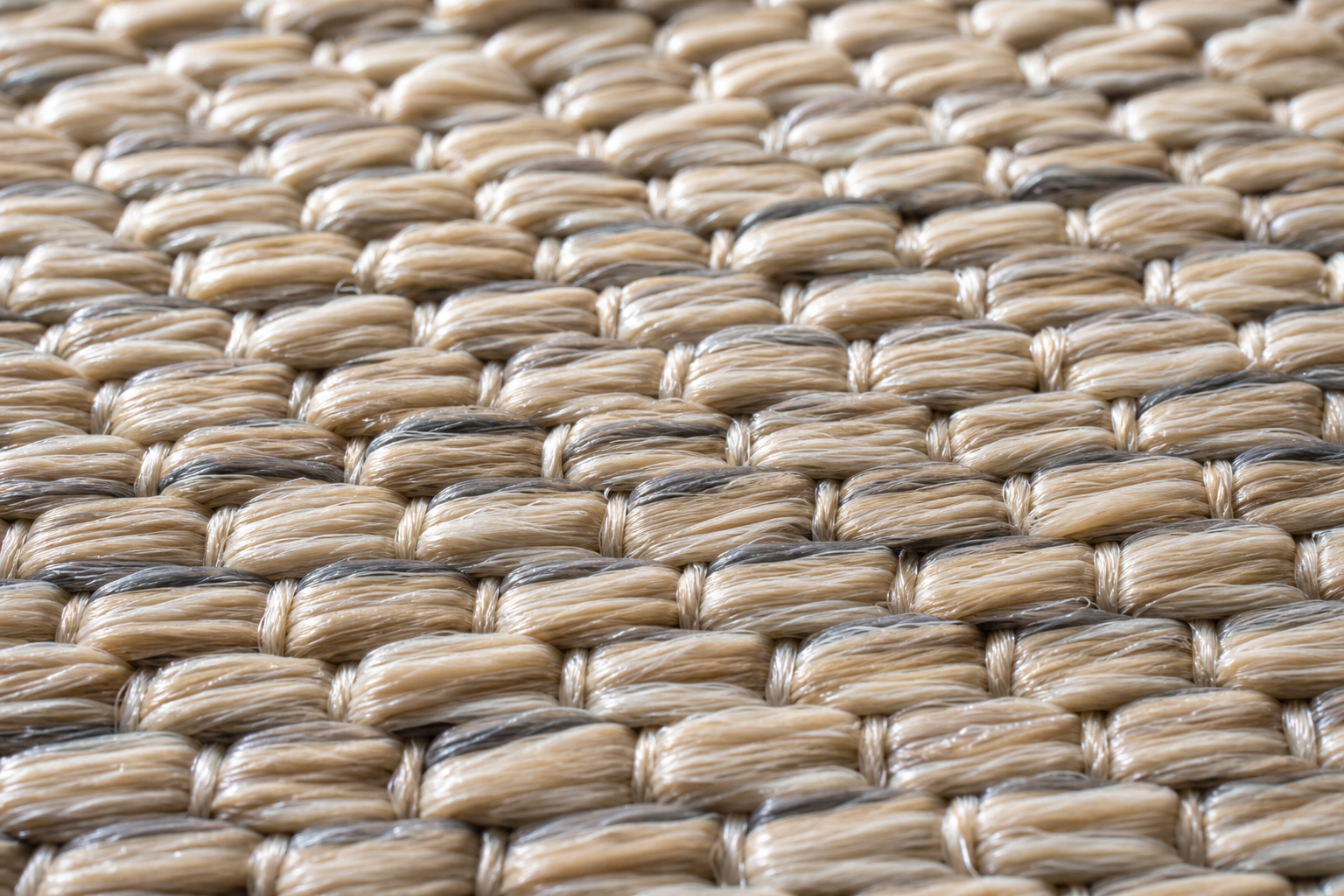 Närbild på flatvävd polypropenmatta med tät fiberstruktur i naturton